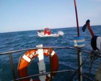 In this photo taken with a cellphone camera, a National Sea Rescue Institute vessel tows the fishing boat, Nikki, back to Ngqura harbour In this photo taken with a cellphone camera, a National Sea Rescue Institute vessel tows the fishing boat, Nikki, back to Ngqura harbour