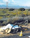 A body lies covered at the scene of an accident near Oudtshoorn in which three cyclists who were training for the Argus Pick n Pay cycle race were killed when a bakkie mowed them down. (Die Burger) A body lies covered at the scene of an accident near Oudtshoorn in which three cyclists who were training for the Argus Pick n Pay cycle race were killed when a bakkie mowed them down. (Die Burger)