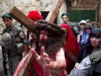 A man depicting Jesus holds a cross as he walks towards the Church of the Holy Sepulchre on Good Friday in Jerusalem's Old City April 6, 2012 (Reuters) A man depicting Jesus holds a cross as he walks towards the Church of the Holy Sepulchre on Good Friday in Jerusalem's Old City April 6, 2012 (Reuters)