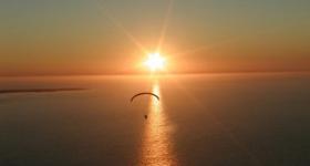 Powered paragliding near Robben Island, off Cape Town, as the sun sets (Photo: Xplora Paramotors)